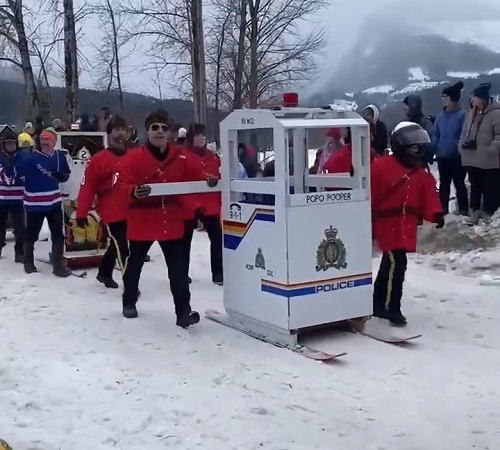Photograph of RCMP officers in Revelstoke, BC participating in the historic outhouse race. Cst. Emily Hacker, Cst. Tiberius Dobni, Cpl. Phil Pauze, Cst. Rachel Mandel