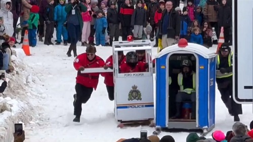 Photograph highlighting S/Sgt. Chris Dodds, Revelstoke Detachment Commander in the outhouse race