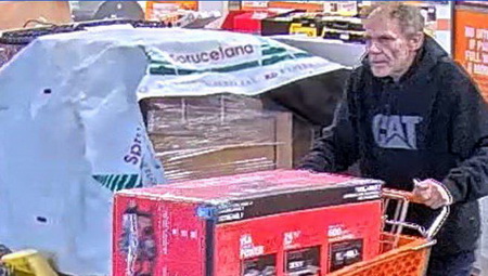 Photo of suspect pushing shopping cart with boxed tools loaded into it