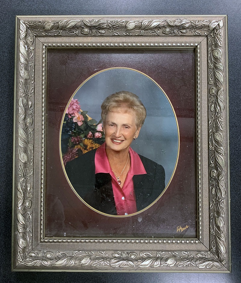 Framed photograph of woman wearing a dark blazer over a bright pink shirt
