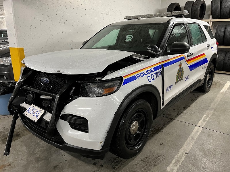 Driver’s side profile of a marked RCMP vehicle with significant front-end damage