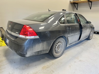 Rear, passenger side view of dark grey Chevrolet Impala
